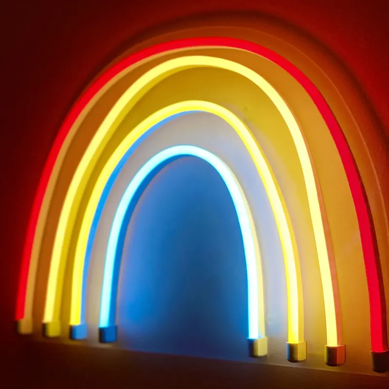 Glowing neon rainbow light on a red wall